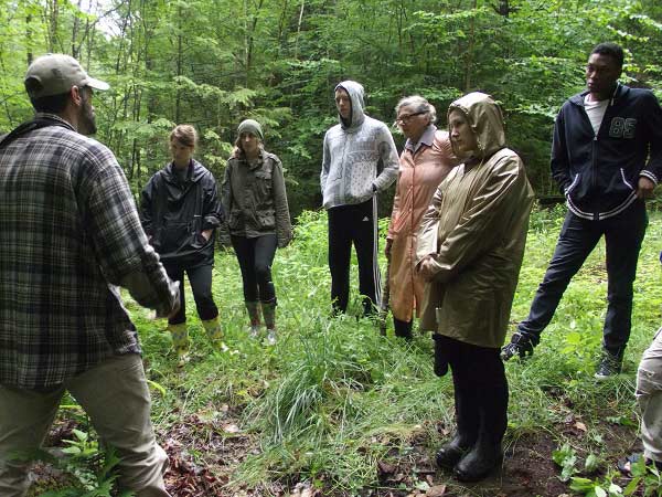 Justin Waskiewicz with group on the woods walk